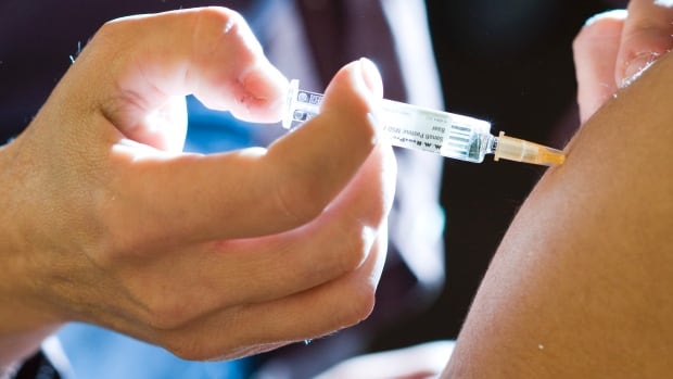 Closeup of needle gong into shoulder.