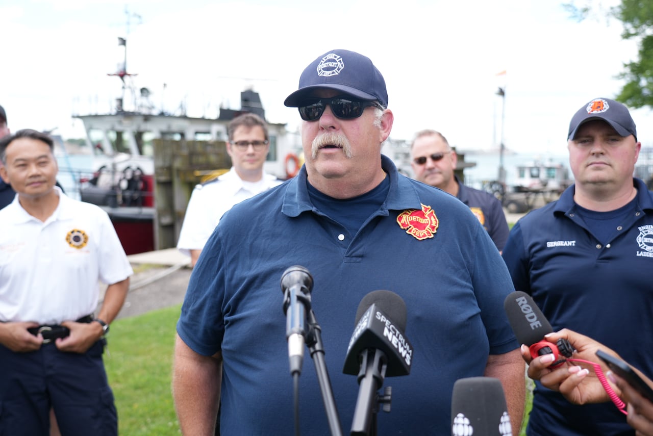 a man with a blue polo black sunglasses and a blue hat