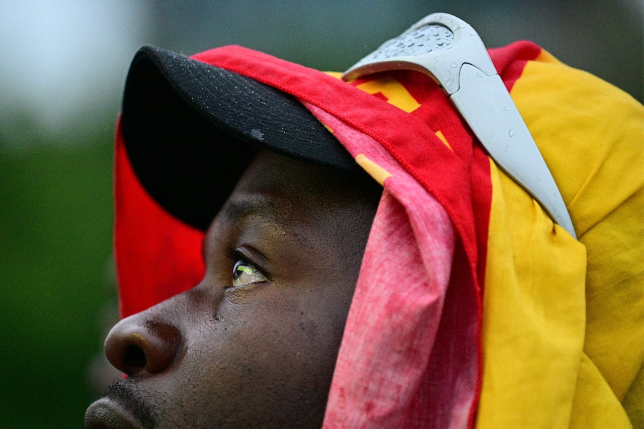 A close up of a fan in Ghana's colours staring upwards.