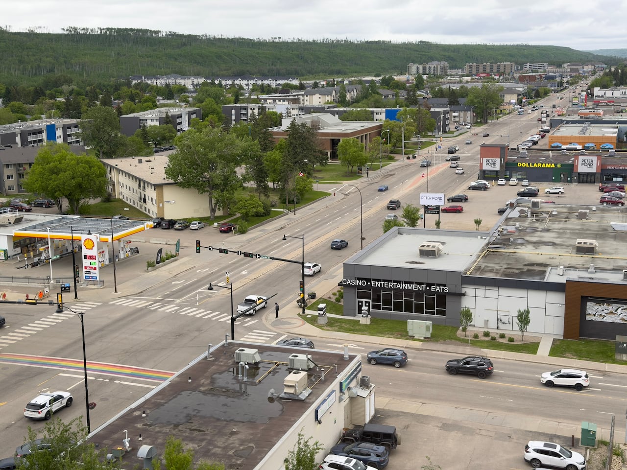 A busy street stretches towards the horizon through a city's downtown.