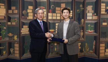 RM, right, the leader of K-pop supergroup BTS, shakes hands with You Hong-june, director of the National Museum of Korea, after being named global ambassador of the museum, in this photo provided by You
