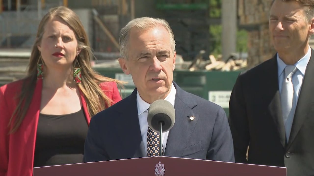 A man speaks at a ppodium.