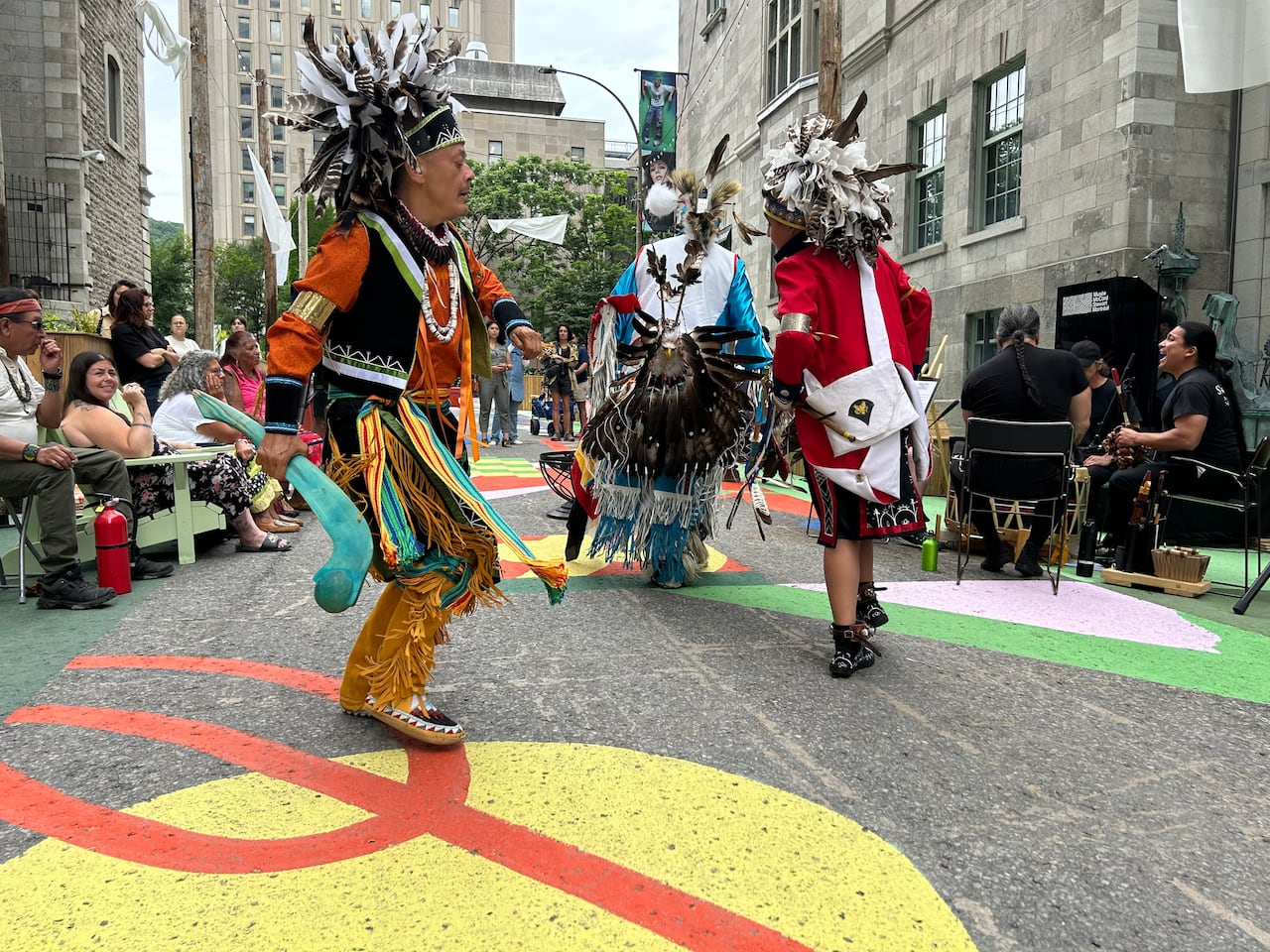 Men in regalia dancing during National Indigenous Peoples Day at the McCord Stewart Museum in Montreal. 