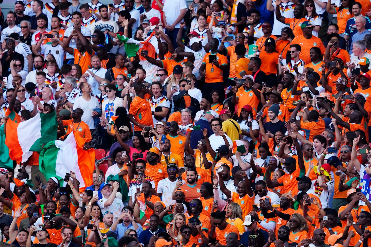 Fans in stands with bright orange jerseys