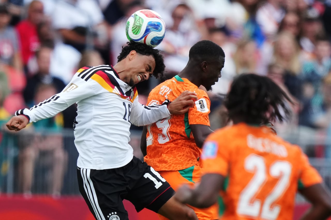 German player header with Ivory Coast players nearby