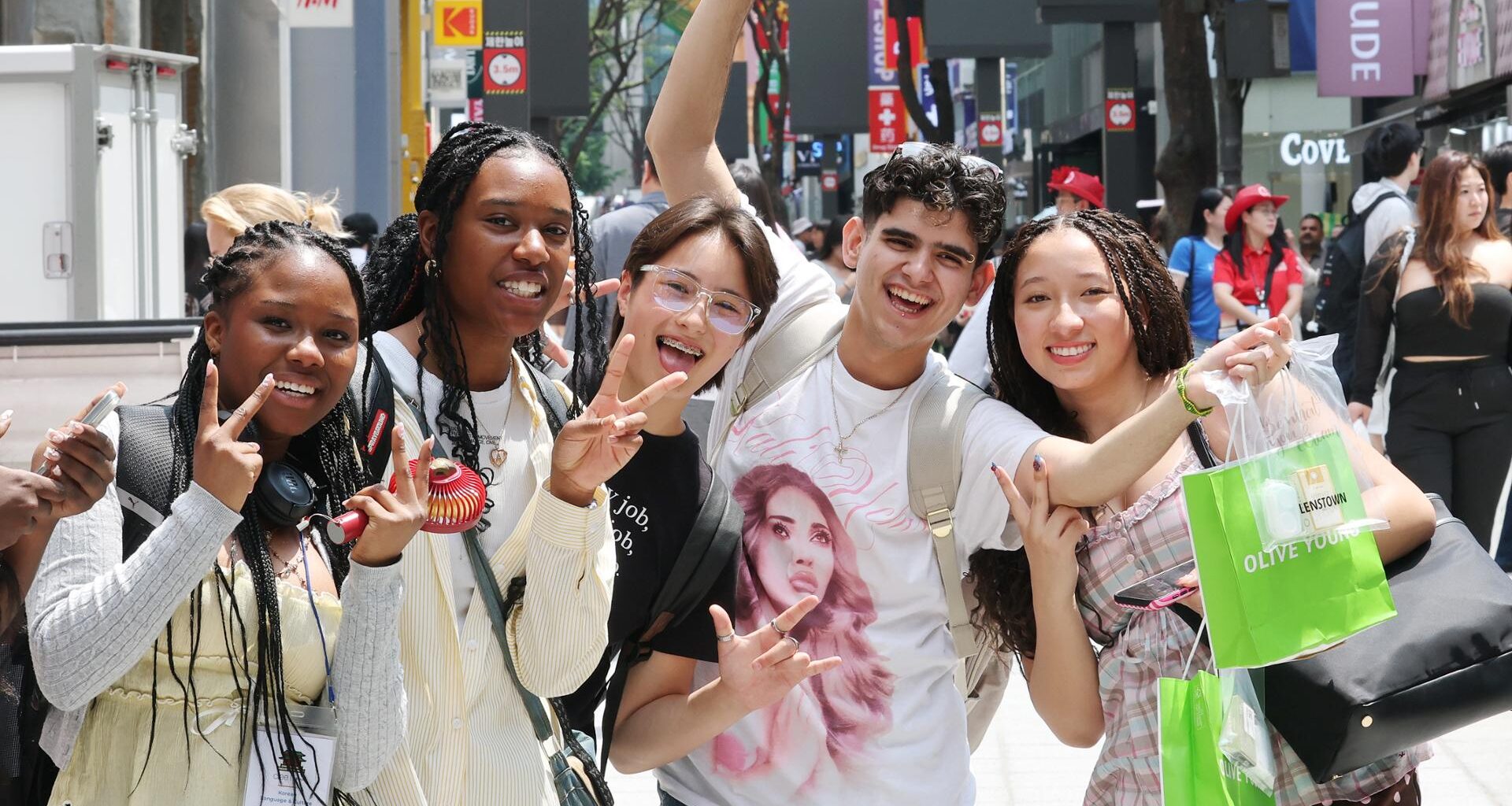 Foreign tourists  pose while visiting Myeong-dong in central Seoul, June 9. Yonhap