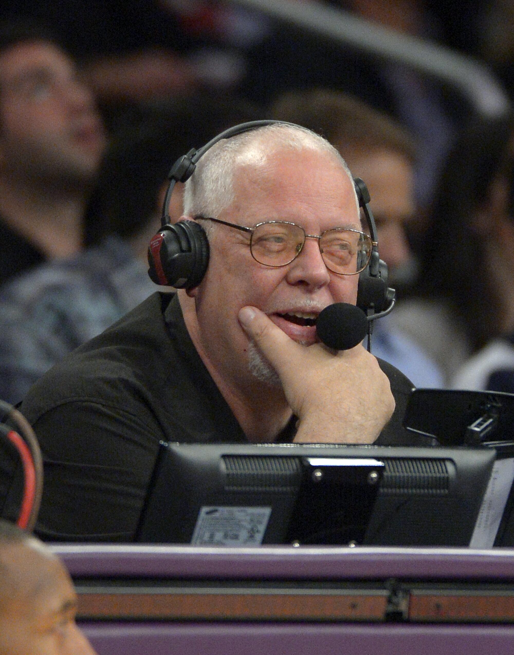 Lakers public address announcer Lawrence Tanter watches play from his spot at the scorer's table during a game in 2012.
