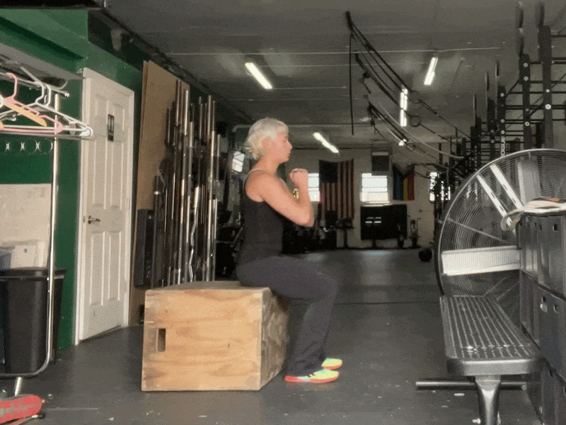 This is a photographic GIF of the sit-to-stand exercise. In this exercise, stand up quickly from a chair and then slowly sit back down.