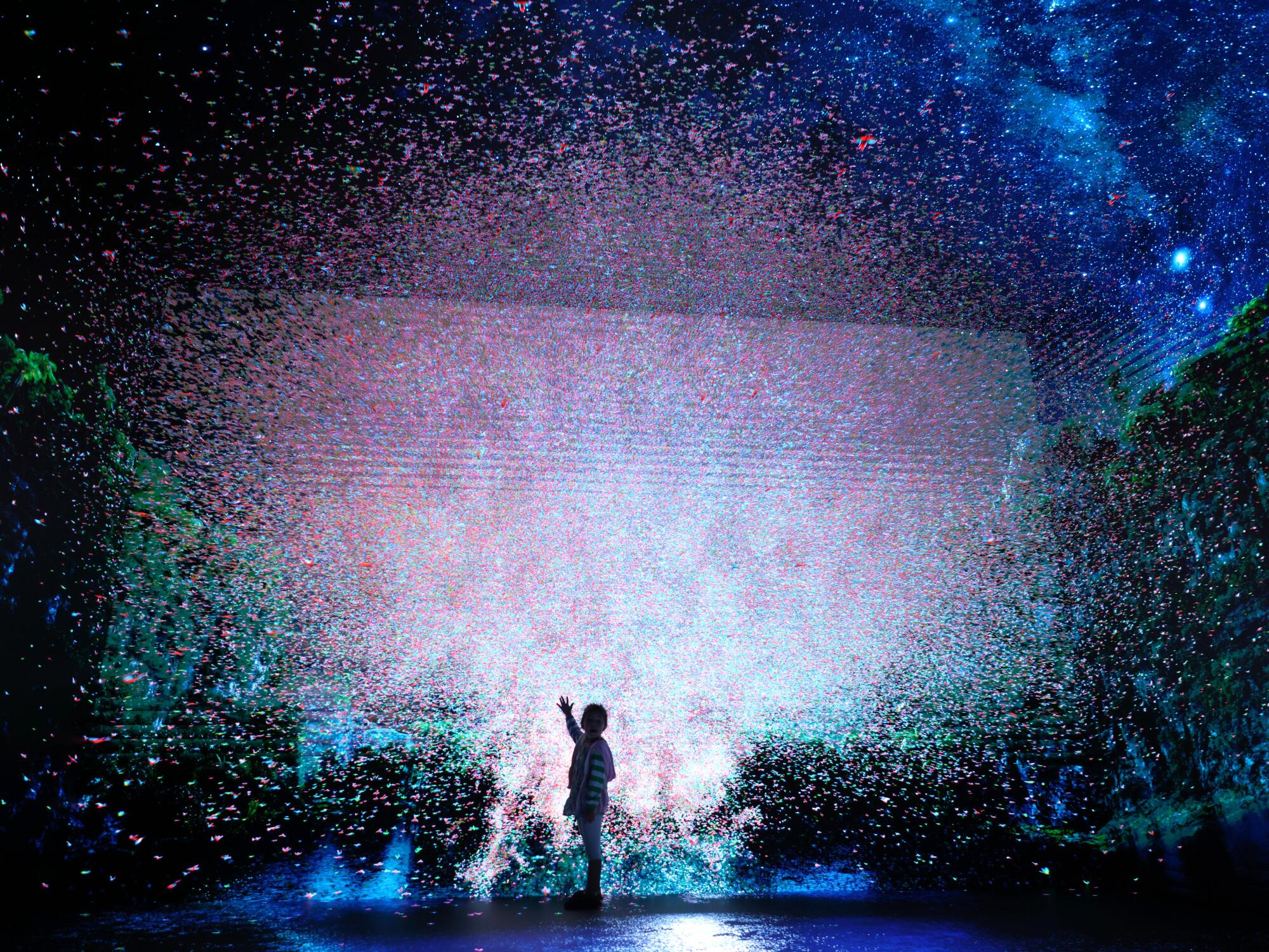 A child watches an explosion of imagery on a giant screen