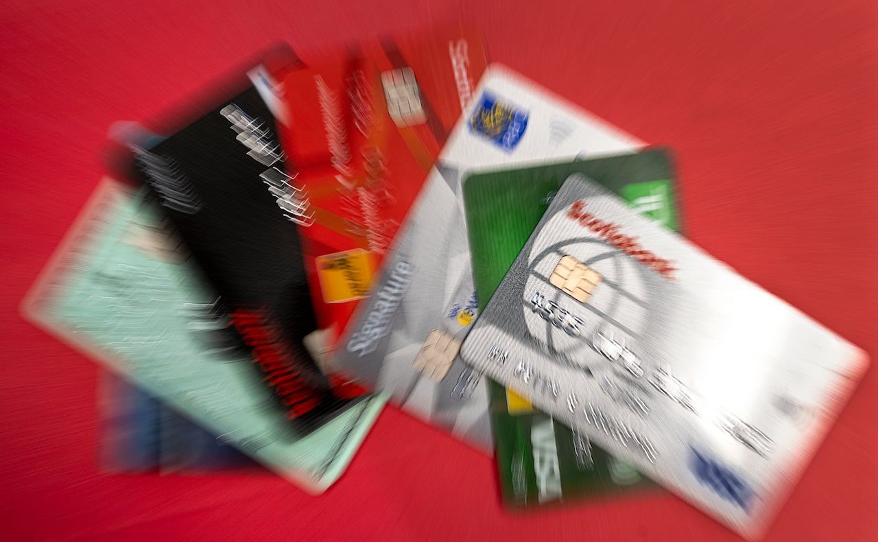 A group of blurred credit cards shown on a red background