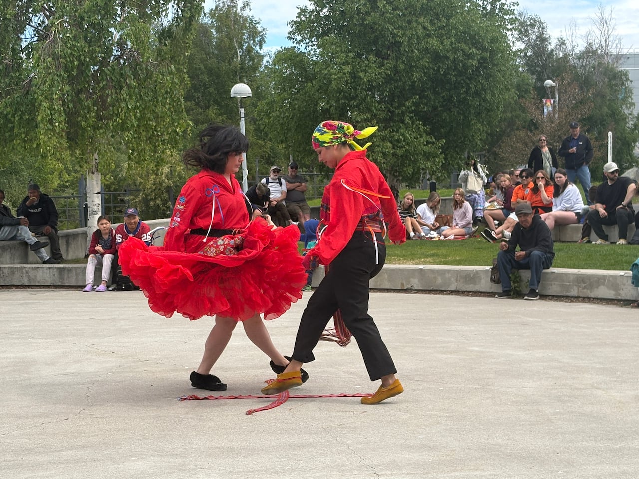 Dancers from the Edmonton Métis Traditional Dancers perform the sword dance over a Métis scarf as part of the entertainment at the North Slave Métis Alliance's Indigenous Peoples Day celebrations.