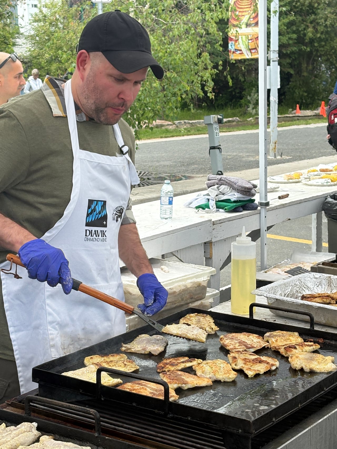 Brian Peers, an RCMP volunteer, mans the grill at the North Slave Métis Alliance fish fry.