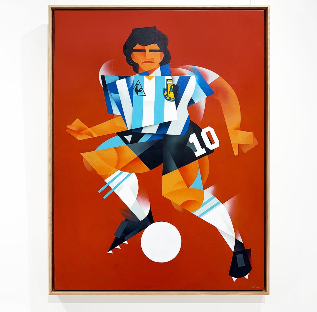 A cubist-style portrayal of Diego Maradona in the pale blue and white striped kit of Argentina on a red-orange background.