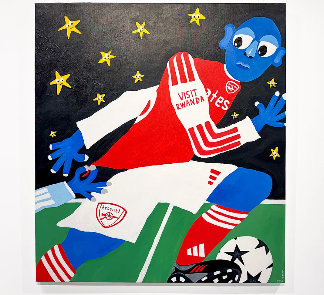 A blue figure in a red Arsenal kit running in front of a night sky