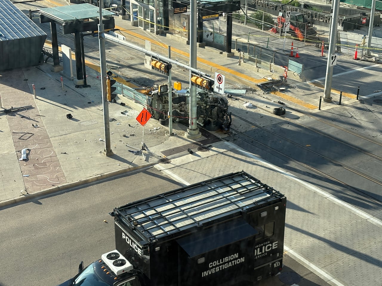 An aerial view of the wreckage of a downtown crash near a set of transit tracks