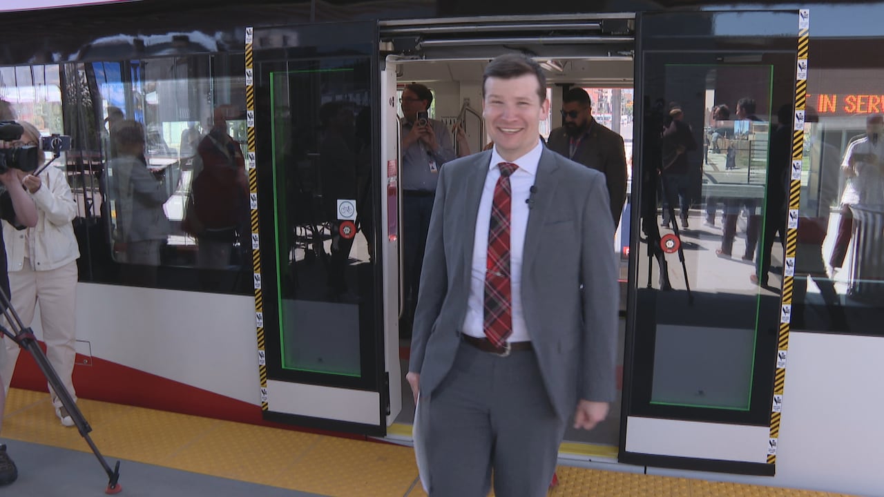 A man steps off a train.
