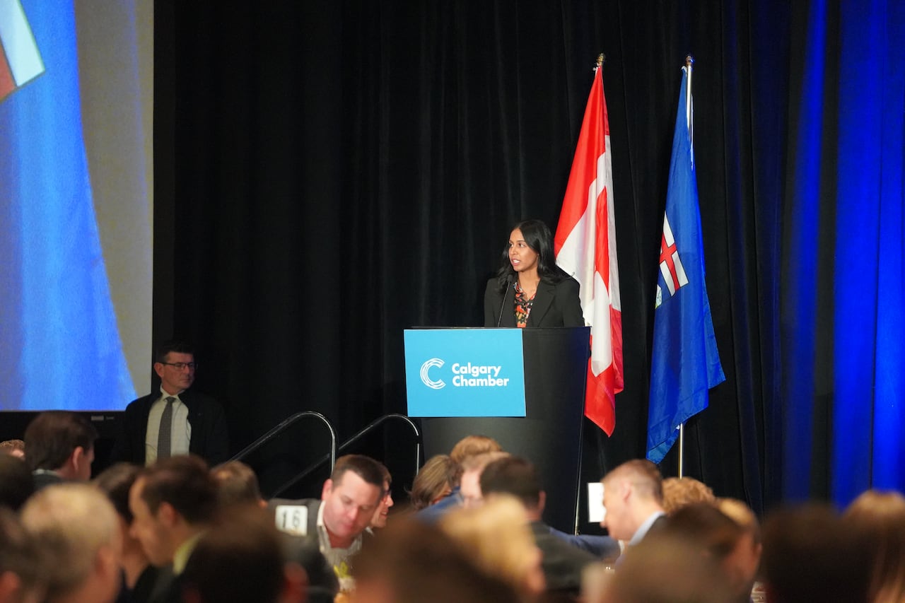 A woman speaks in front of a crowd.1