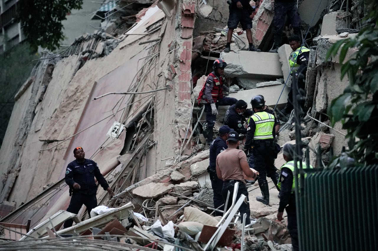 Emergency workers searching the rubble of a collapsed building