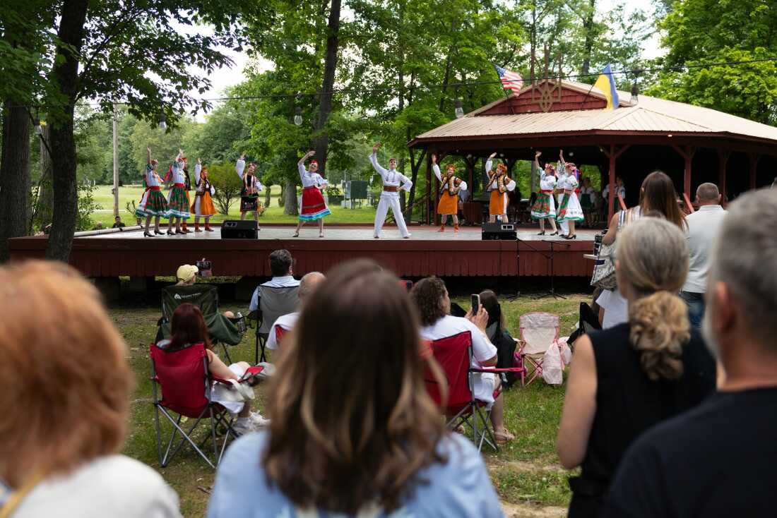 Dancers with the Voloshky Ukrainian Dance Ensemble, who are wearing traditional clothing, perform on an outdoor stage at the heritage festival at Tryzub Ukrainian American Sport Center on June 21.
