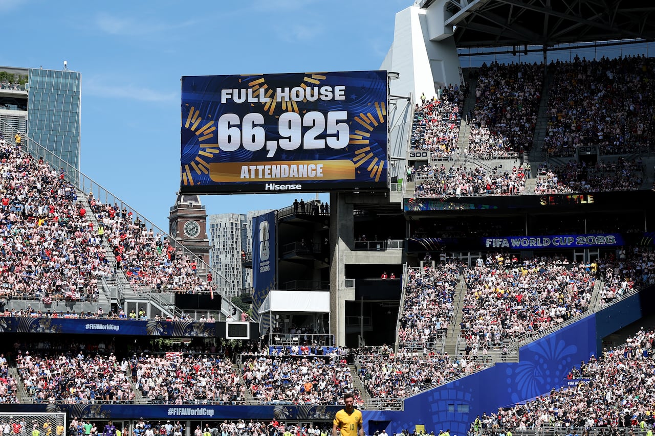 A sign inside a sports stadium shows the full house attendance.