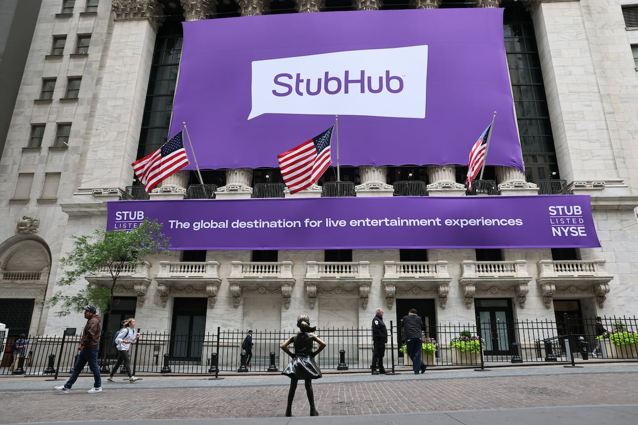A massive purple Stubhub banner hangs on the outside of a white building.
