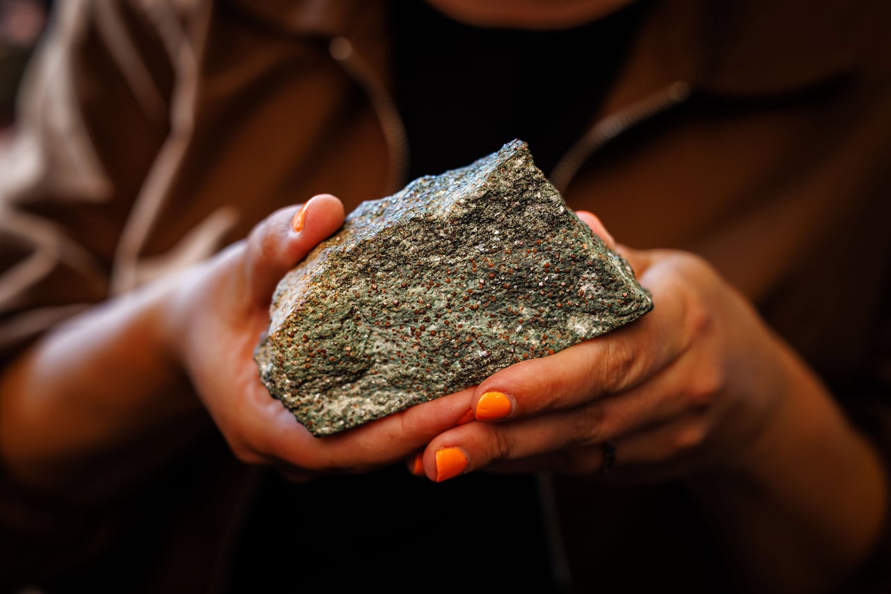 Tanya holds a garnet-bearing rock to show what it looks like.