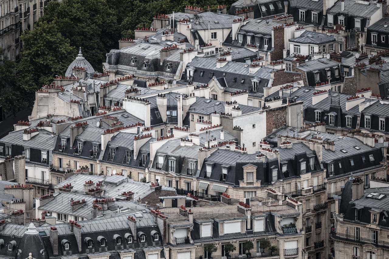 An aerial photo of blueish-gray roofs in Paris.