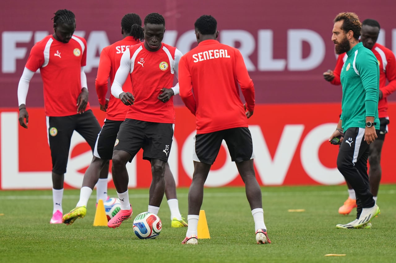 Soccer players practice on a field.