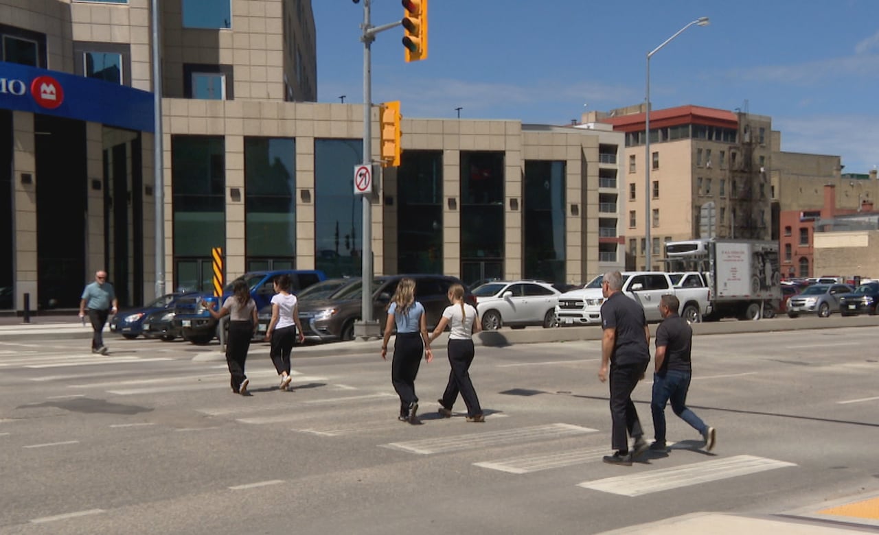 People walk across an intersection