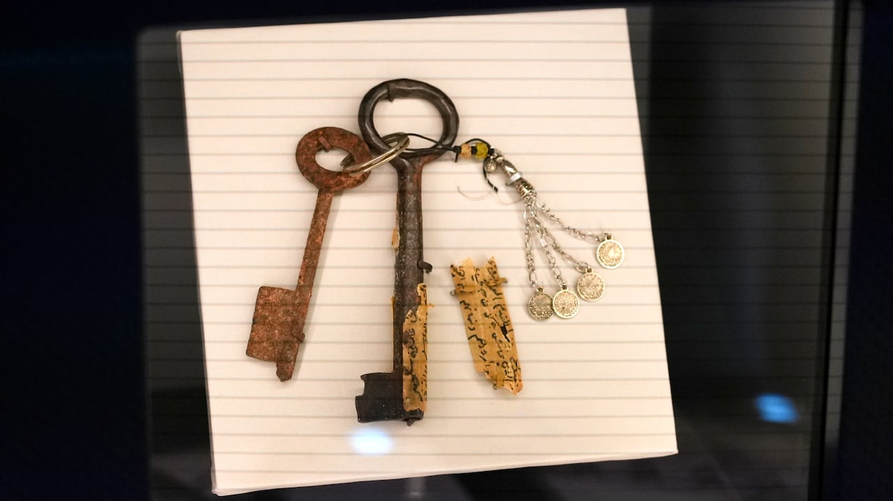 A pair of keys are encased in glass.