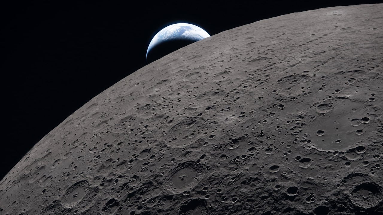 A view of the moon and the Earth behind it.
