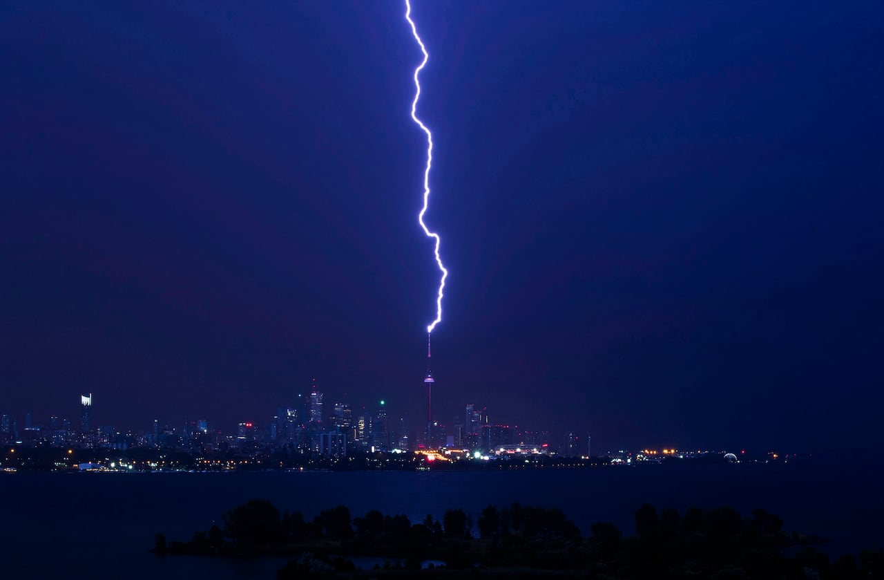 A lightning bolt strikes the CN Tower during an electrical storm in Toronto, Thursday July 14, 2016. THE CANADIAN PRESS/Mark Blinch