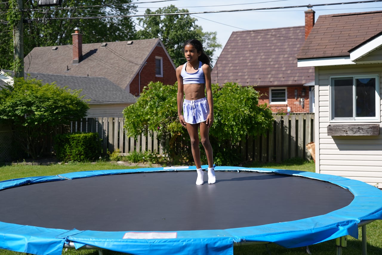 A girl on a trampoline.
