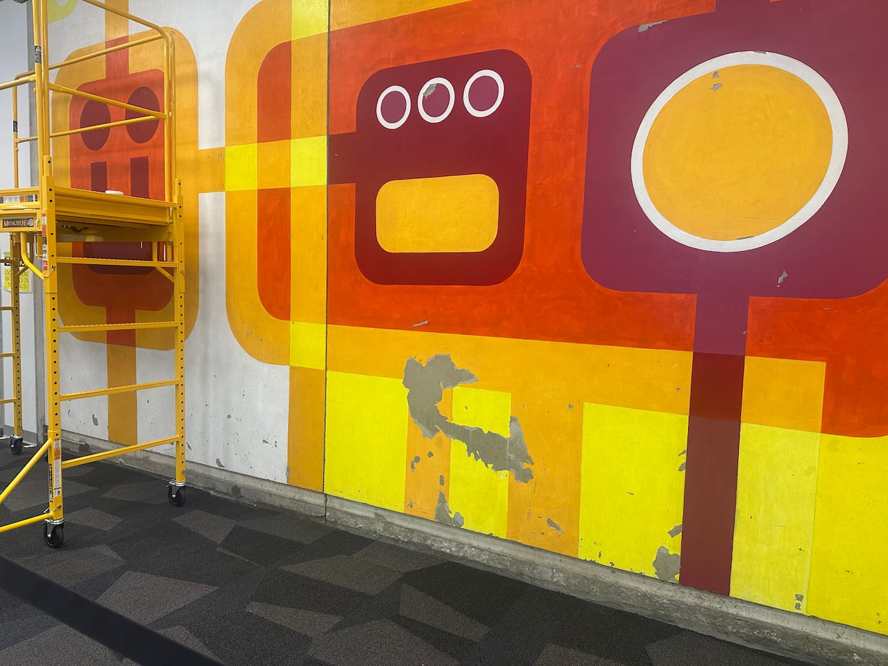 Peeling paint, gouges and indents are all part of the damage that Robert Oldrich's murals have taken in the past 52 years, that art conservators are working to repair.