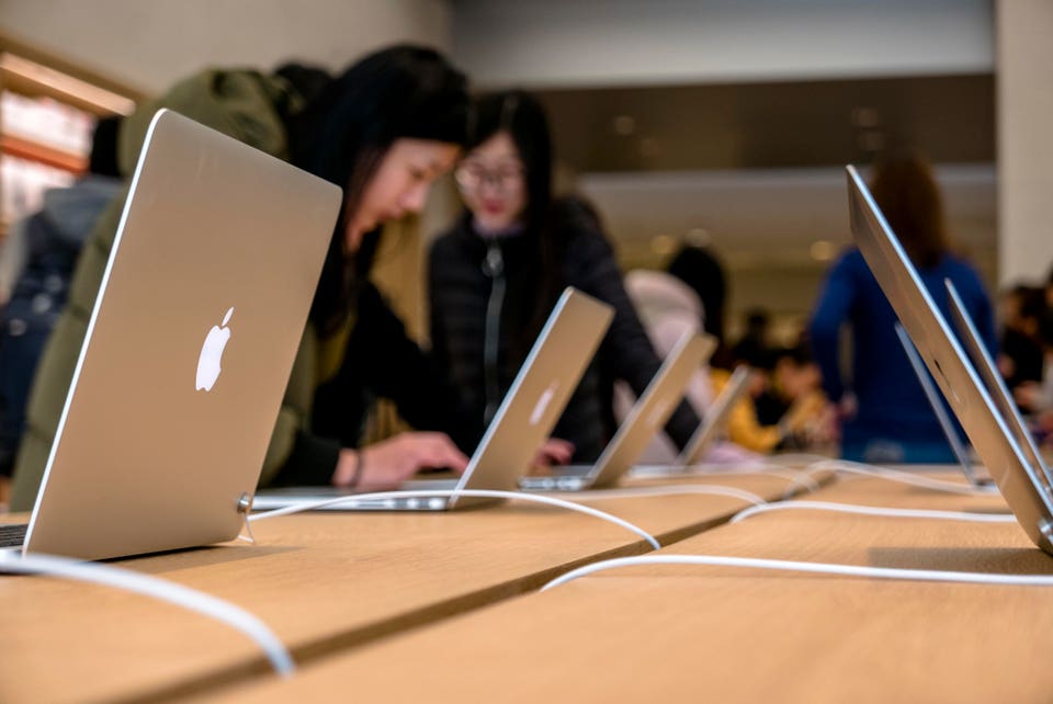 Chinese customers in the new Apple shop. On the March 25,...