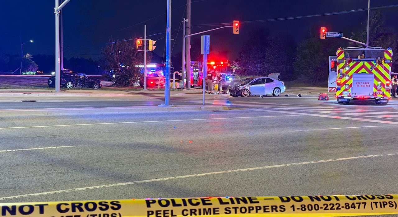 Emergency vehicles around two crashed cars