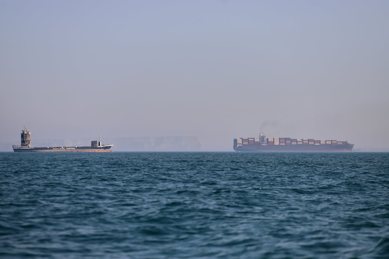 Industrial ships are seen at sea.