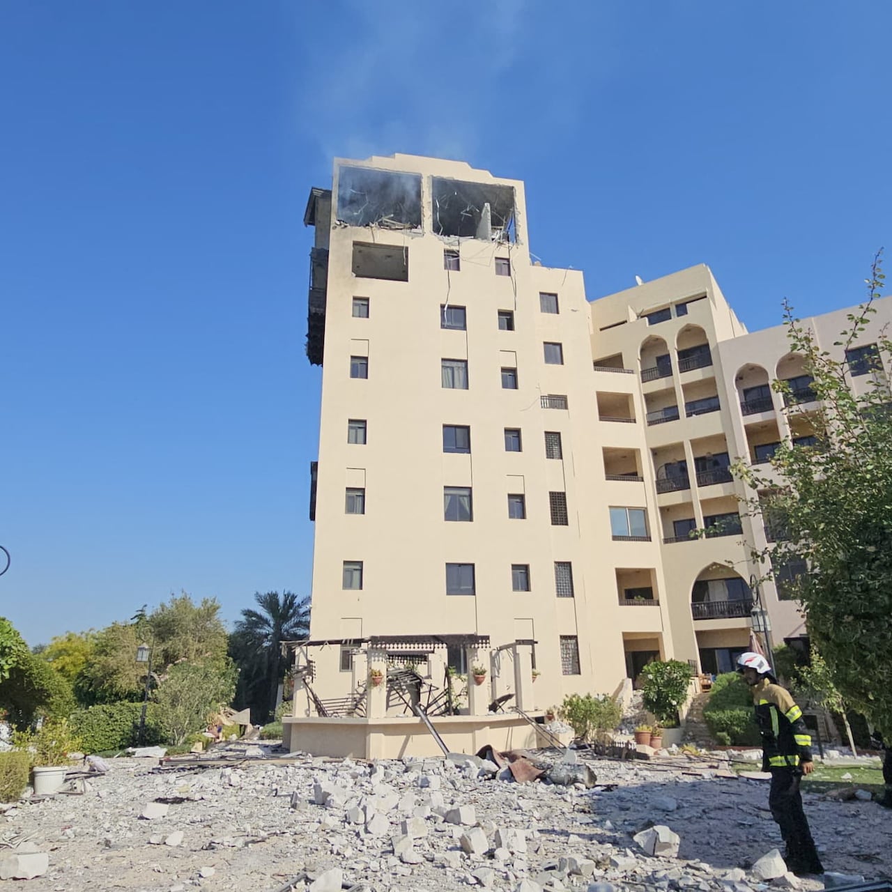 A building is seen with the top floor damaged.