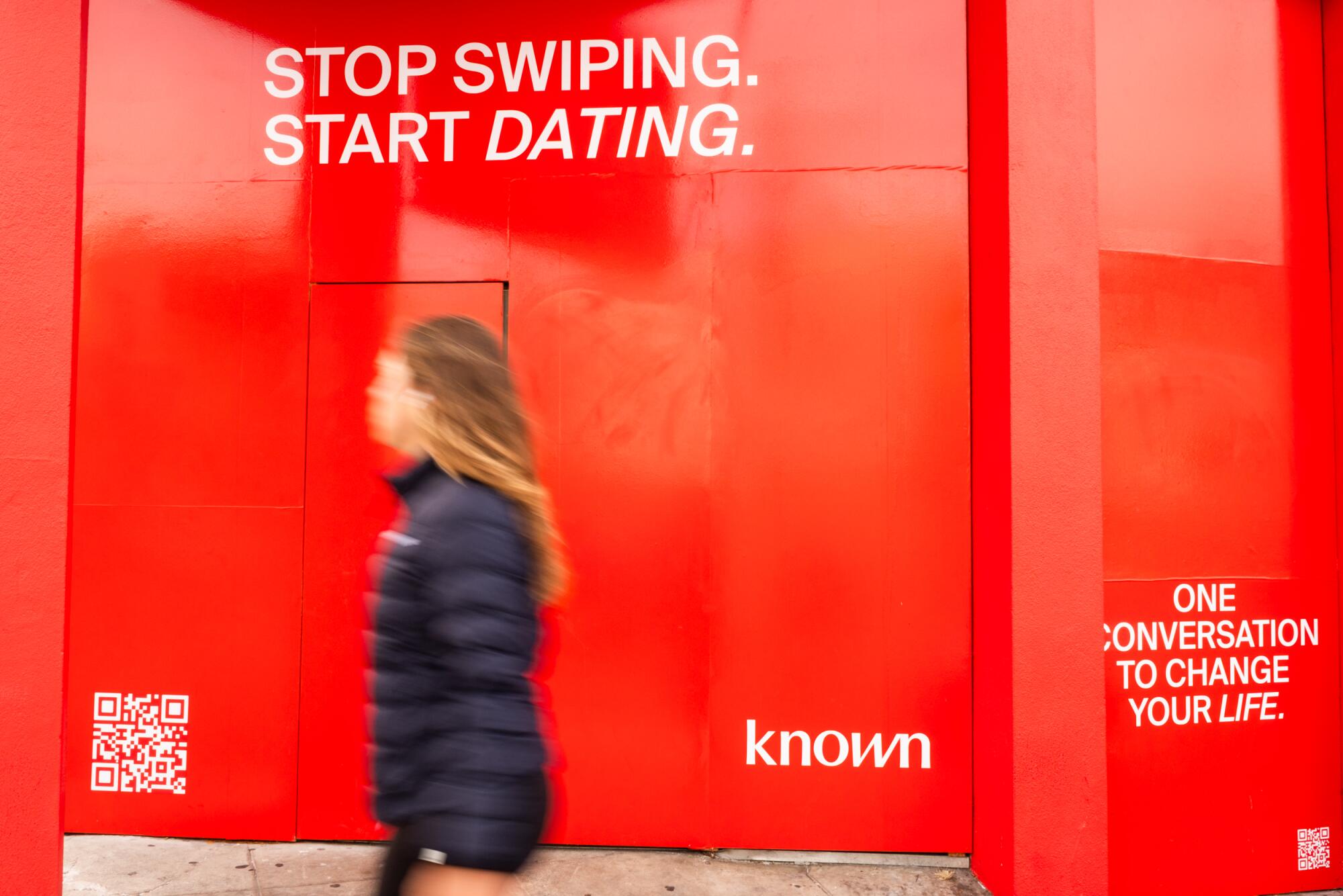 Known, an AI dating app, has their branding plastered on a store front in San Francisco's Marina District.