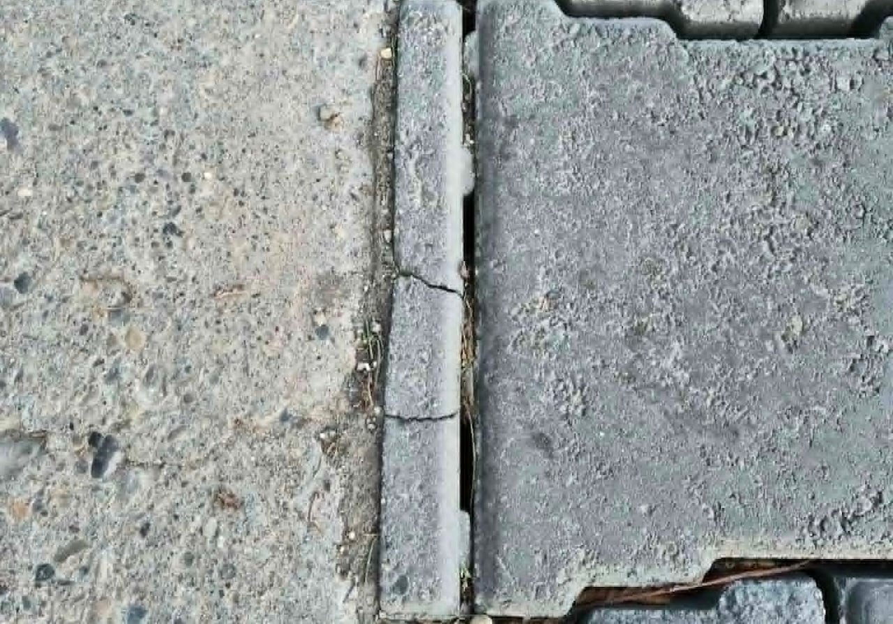 A close-up of a cracked paving stone