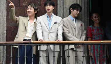 From left, J-Hope, Jin and V from K-pop boy band BTS acknowledge fans past Mexico President Claudia Sheinbaum from the balcony of the National Palace at Zocalo square in Mexico City, May 6. AFP-Yonhap