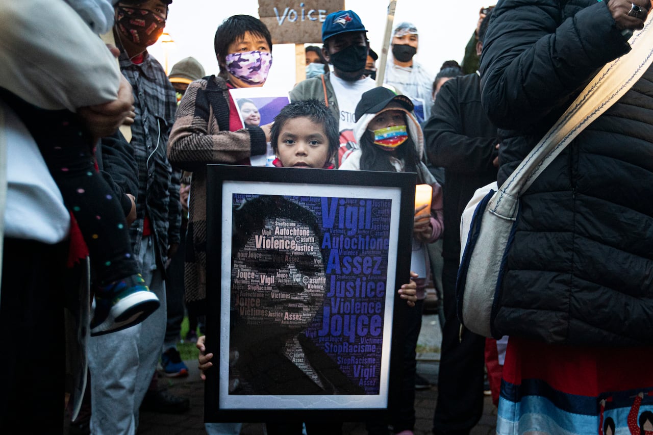 Child holds sign