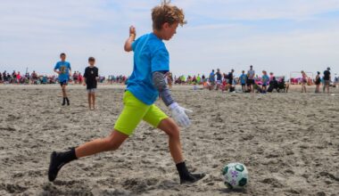 Kids play soccer in the sand during Cape Express Beach Blast