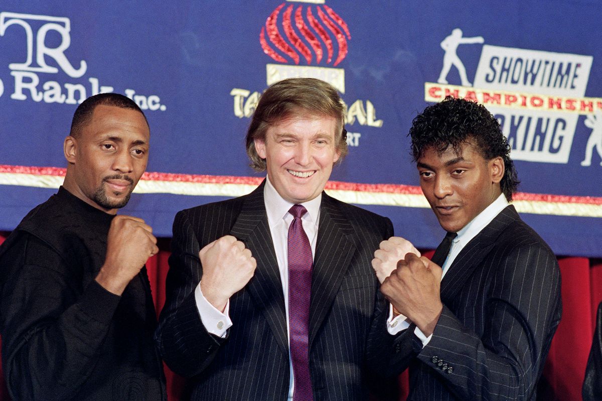 Michael lines up with Thomas Hearns and Donald Trump ahead of their title fight at Trump's hotel in April 1990