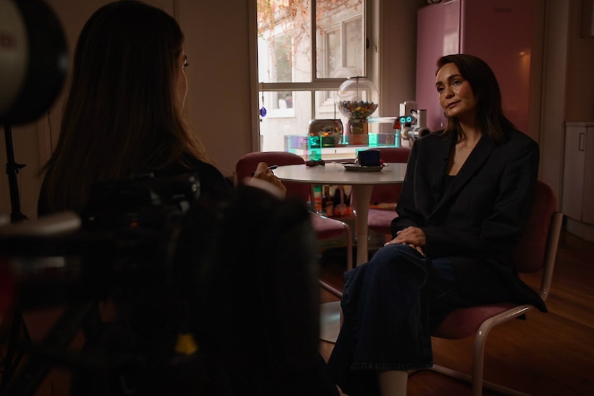 Woman seated for an interview with a female reporter.