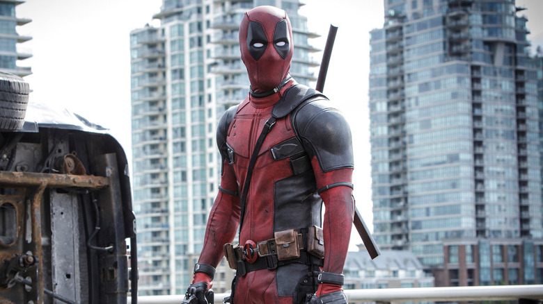 Deadpool stands in the middle of the street in Deadpool.