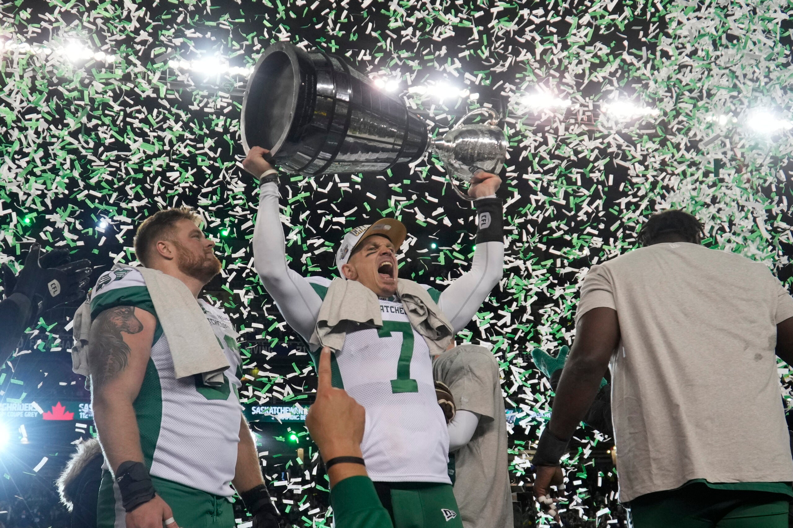 Nov 16, 2025; Winnipeg, Manitoba, Canada; Saskatchewan Roughriders quarterback Trevor Harris (7) lifts the Grey Cup in celebration of the win against the Montreal Alouettes during the 112th Grey Cup Championship at Princess Auto Stadium.