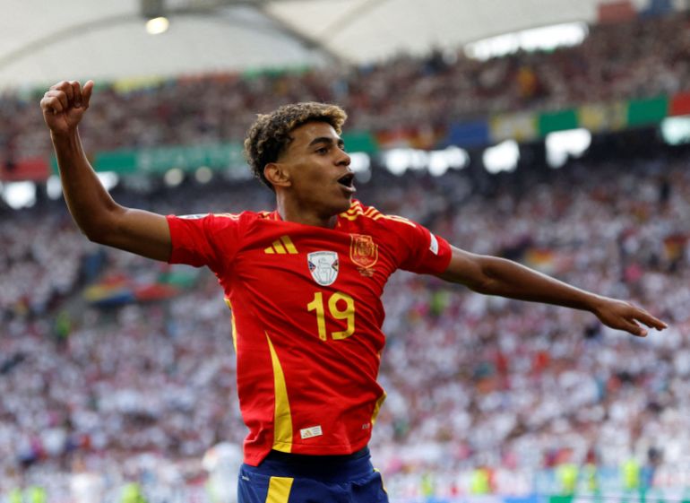 Spain's Lamine Yamal celebrates after Dani Olmo scores their first goal