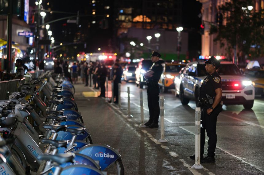 NYPD officers guard Eighth Avenue during a watch party for the NBA Finals Thursday in New York City.