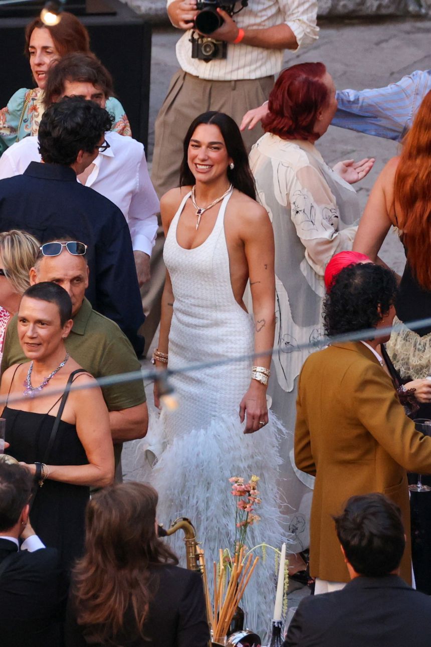 After marrying in London in a Schiaparelli skirt suit, Lipa stepped out in a white leather woven Bottega Veneta dress with ostrich feathers for the Palermo party.